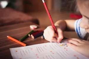 young schoolmate writing