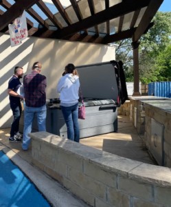 Gohlke Pools rep showing customers a Sundance Spa