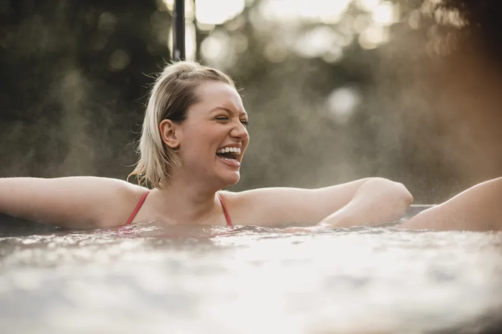 Happy woman in a hot tub.