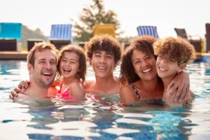 Picture of a happy mulit-cultural family in a swimming pool.